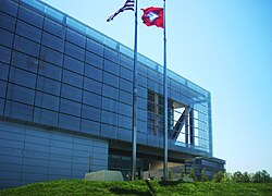 The glass screen, which acts as a sunscreen, is on the main building's western face.