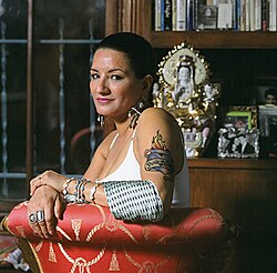 Sandra Cisneros, best known for her first novel The House on Mango Street (1983) and her subsequent short story collection Woman Hollering Creek and Other Stories (1991). She is the recipient of numerous awards including a National Endowment for the Arts Fellowship, and is regarded as a key figure in Chicana literature.[73]