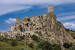 Ruined stone buildings of the medieval village of Craco on a hilltop