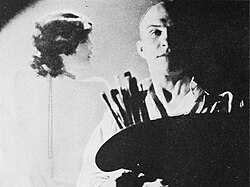 Armstrong in his studio, with one of his so-called "Armstrong Girls" in the background. (1930)