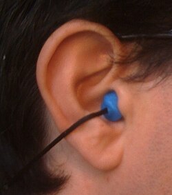Man wearing protective ear plugs