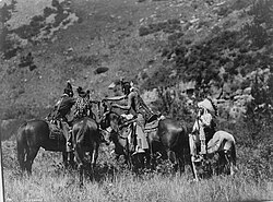 Crow men trading on horseback