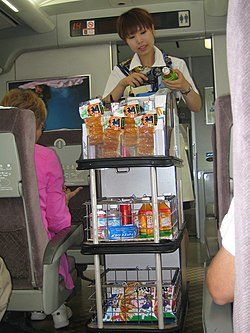 Snack vendor on the Shinkansen train scans a barcode.