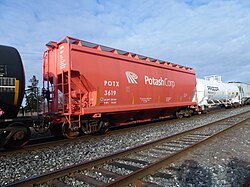 A covered hopper car in a Canadian train for shipping potash by rail