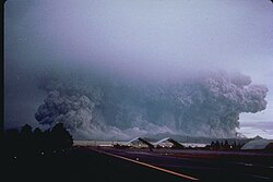 A view to the west from Clark Air Base of the major eruption of Pinatubo on June 15, 1991. The June 15–16 climactic phase lasted more than fifteen hours, sent tephra about 35 km (22 mi) into the atmosphere, generated voluminous pyroclastic flows, and left a caldera in the former summit region. Later dubbed Black Saturday, the day of darkness stretched for 36 hours.