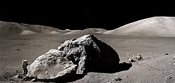 Apollo 17 astronaut Harrison H. Schmitt next to the large Moon boulder nicknamed "Tracy's Rock" in the Taurus–Littrow of the Mare Serenitatis on the near side of the Moon