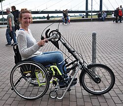 Wheelchair propelled by attached handcycle