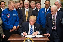 President Trump signs an executive order re-establishing the National Space Council, with astronauts Dave Wolf and Al Drew, and Apollo 11 astronaut Buzz Aldrin (left-to-right) looking on.