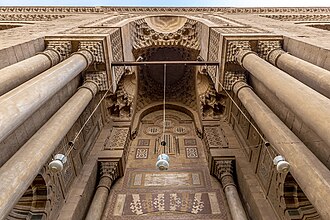 Detail of the entrance portal of the al-Rifa'i Mosque, which exemplifies the revival of Mamluk-style decoration, including ablaq (polychrome stonework), Arabic inscriptions, and muqarnas