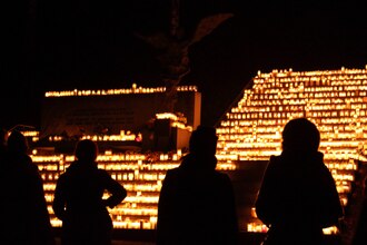 Candles lit at memorial to passed generations and loved ones lying elsewhere in Hietaniemi Cemetery (in Helsinki, Finland) on All Saints' Day