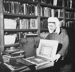 Scholar holding a Quranic manuscript at the University of al-Qarawiyyin's library in Fes