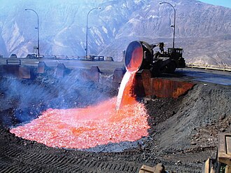 Molten slag is carried outside and poured into a dump. Caletones copper smelter in El Teniente mine, Chile.