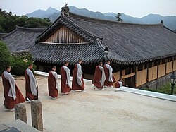 Monks going down to their rooms after evening prayers at Haeinsa.