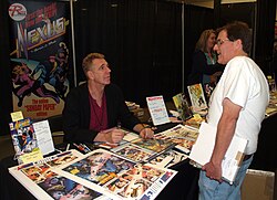 Rude (left) speaking with a fan at an April 2016 comics convention.