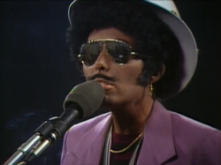 Mitchell in blackface while performing "Furry Sings the Blues" during her 1980 concert film Shadows and Light.
