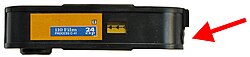 A 110 cartridge of ISO 400 film. The arrow indicates the modification made so that sophisticated cameras detect the proper film speed.