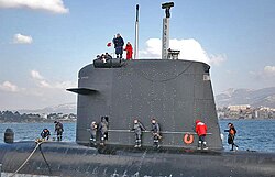 Sail of the French nuclear submarine Casabianca; note the diving planes, camouflaged masts, periscope, electronic warfare masts, hatch, and deadlight.