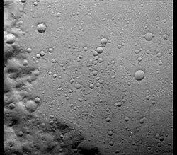 Viking orbiter view of Hesperian-aged surface in Terra Meridiani. The small impact craters date back to the Hesperian Period and appear crisp despite their great age. This image indicates that erosion on Mars has been very slow since the end of the Noachian. Image is 17 km across and based on Carr, 1996, p. 134, Fig. 6-8.[32]
