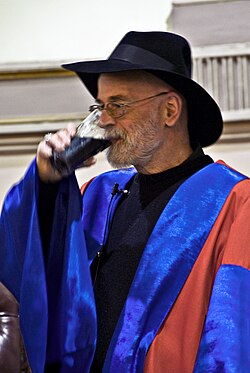 Pratchett drinking Irish stout shortly after receiving an honorary degree from Trinity College Dublin, in 2008