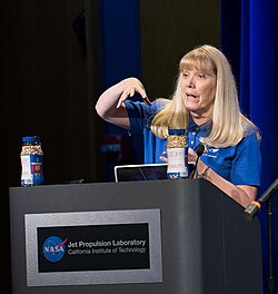 Linda Spilker explains the tradition of lucky peanuts at a gathering for Cassini mission team members, family and friends in Von Karman Auditorium at JPL, 2017