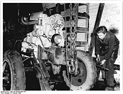 A tractor being mechanically repaired in Werneuchen, 1966