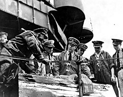 Captain Homer N. Wallin (center) supervises salvage operations aboard USS California in early 1942.