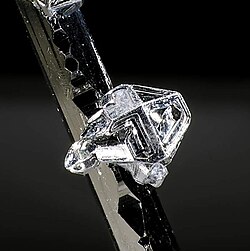 Native tellurium crystal on sylvanite (Vatukoula, Viti Levu, Fiji). Picture width 2 mm.