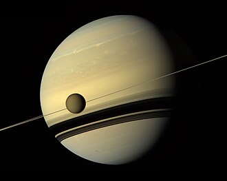 The moon Titan is darker than Saturn even though they receive the same amount of sunlight. This is due to a difference in albedo (0.22 versus 0.499 in geometric albedo).