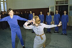 Ford joining dance students at the May 7th College of Art in Beijing, China (December 3, 1975)