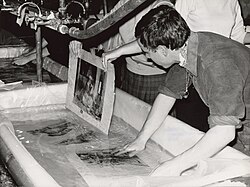 Responders to the flooding of the Arno in Florence washing a manuscript.