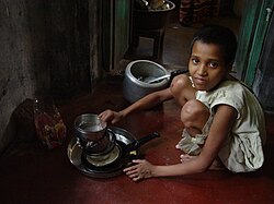 Child maid servant in India. Child domestic workers are common in India, with the children often being sent by their parents to earn extra money, although it is banned by the government.