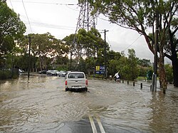 A car driving on a flooded road in Melbourne, Australia.