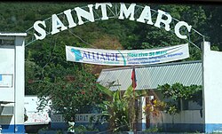 French signs in Saint-Marc; it also incorporates the Creole phrase nou rive, "we have arrived."