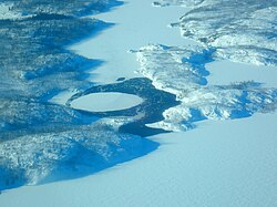 Frozen landscape in the Northwest Territories of Canada. A large ice circle can be clearly seen floating on water.[40][41]