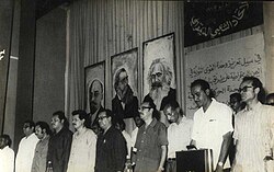 Ali Nasser, Abdul Fattah Ismail, and Abdullah Badheeb at the Democratic Popular Union Party Festival in the 1970s, with portraits of Karl Marx, Friedrich Engels, and Vladimir Lenin behind them
