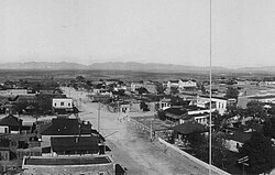 Third St. in Tombstone, Arizona in 1909 from the roof of the Cochise County Courthouse. The O.K. Corral was located on Allen St., the first right turn off Third St. The white building at the center right is Schiefflin Hall on Fremont St. The gunfight took place on Fremont St. between C.S.Fly's photo studio & the Harwood House. Fly's is the first visible structure after the right turn on Fremont St. and the vacant lot where the fight commenced is visible.