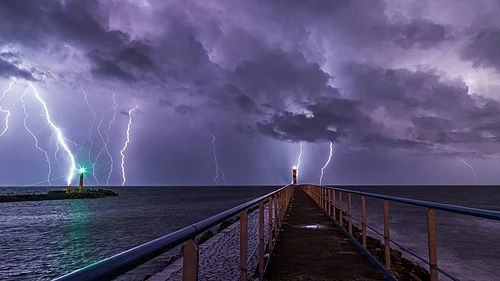 Strokes of cloud-to-ground lightning strike the Mediterranean Sea off of Port-la-Nouvelle in southern France.
