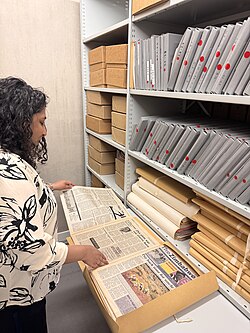 Image of archivist with archival materials in the repository