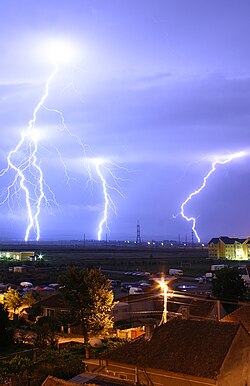Lightning is an example of plasma present at Earth's surface. Typically, lightning discharges 30,000 A at up to 100 MV, and emits light, radio waves, and X-rays.[17] Plasma temperatures in lightning might approach 30,000 K (29,700 °C; 53,500 °F), and electron densities may exceed 1024 m−3.