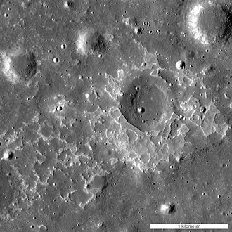 An irregular mare patch in the Mare Tranquillitatis. Note that the image may appear depth inverted; the large round object in the upper right corner is a crater and the large round object in the center is a dome.