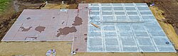 A foundation with pipe fixtures coming through the sleeves