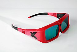 A pair of LC shutter glasses used to view XpanD 3D films. The thick frames conceal the electronics and batteries.