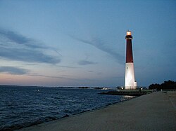 Lighthouse at the coast of Ocean County, New Jersey, U.S., facing the Atlantic Ocean at sunrise