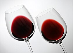 The effect of oak aging on two Penedès region Cabernet Sauvignon varietals, a two-year-old cosecha (left) and six-year-old crianza (right). As the wine matures, its color shifts from deep purple or crimson to a lighter brick-red, and takes on a more graduated appearance in the glass.