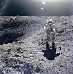 Astronaut Charles Duke working on the Moon with his suit covered in lunar dust. Lunar dust is highly abrasive and can cause damage to human lungs and nervous and cardiovascular systems.[117]