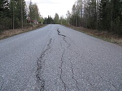 Asphalt damaged by frost heaves