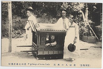 Male servants carrying a palanquin and female maid with a traditional fan (Korea c. 1904)