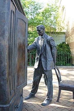 Ross Wilson's statue of Professor Kirke (Digory) in front of the wardrobe from The Lion, the Witch and the Wardrobe in East Belfast