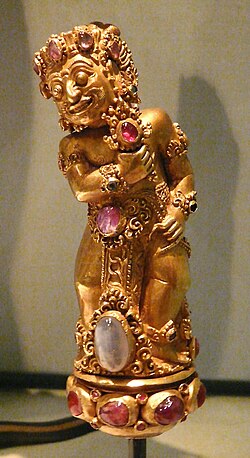 Richly decorated Balinese kris hilt coated with gold, adorned with rubies
