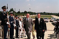Secretary of Defense William S. Cohen escorts Spielberg through a military honor cordon into the Pentagon in 1999